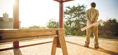 image of a worker standing in a building frame