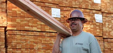 image of a man carrying lumber